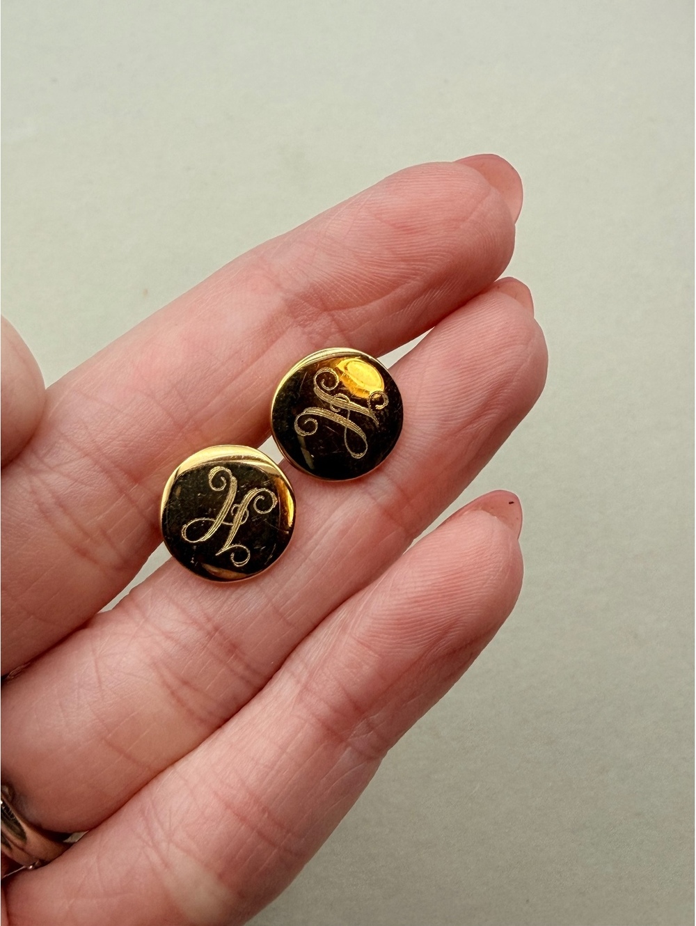 Black round monogram stud earrings